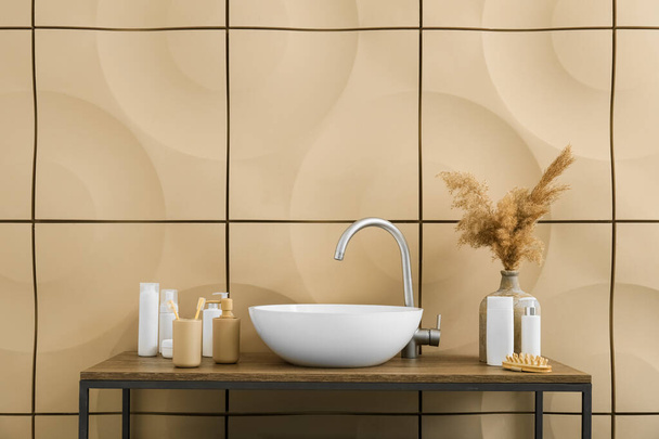 Modern sink and bath accessories near tile wall in bathroom - Zdjęcie, obraz