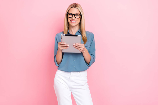 Photo of young positive successful rich manager woman wear stylish smart casual outfit nice glasses hold tablet browsing isolated on pink color background. - Fotoğraf, Görsel