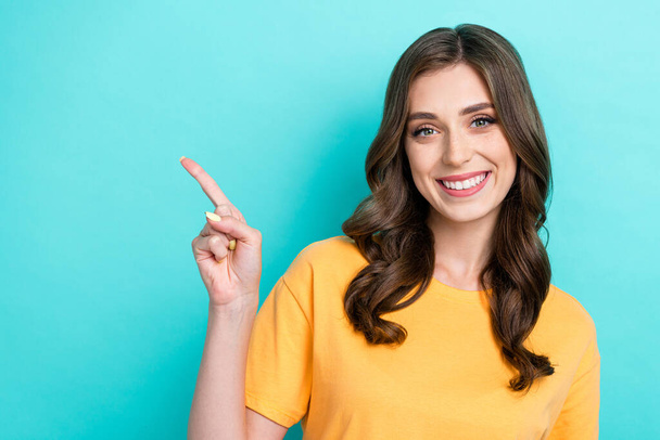 Photo of adorable pretty lady wear stylish yellow clothes arm direct empty space cool proposition sale isolated on cyan color background. - 写真・画像
