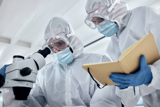 Scientists hazmat suit, microscope and laboratory research planning, dna test and corona virus vaccine development. Professional science team, medical workers and healthcare analysis in safety ppe. - 写真・画像