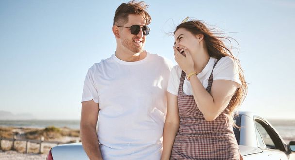 Road trip, couple and love with a man and woman laughing while enjoying travel and tourism together during summer. Happy, smile and romance with a young male and female on a trip or vacation. - Photo, Image
