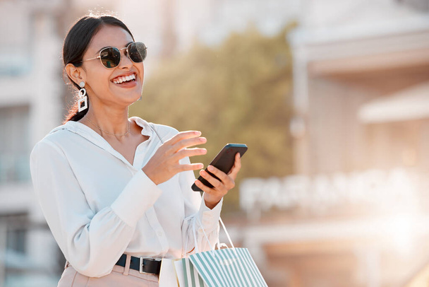 Fashion, shopping and bag with woman and phone for social media, sale and retail in New york city street. Luxury, customer and gift with girl and 5g for internet, communication or contact with mobile. - Photo, Image