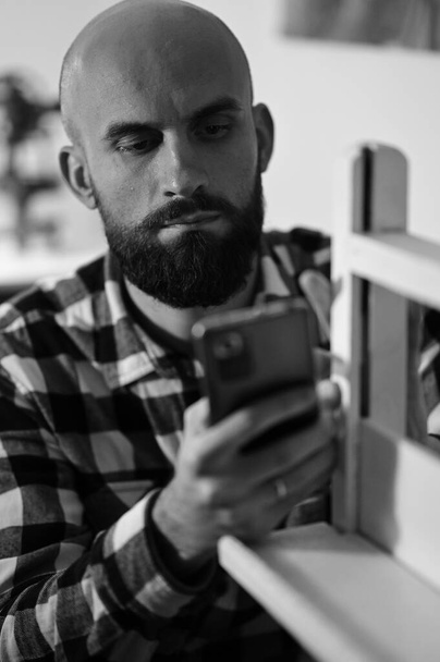close up portrait of bald bearded man in plaid shirt - Foto, Imagen