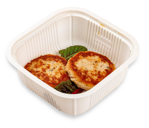 Fried chicken cutlets. In a plastic container. Food to go. On a light background. - Photo, image