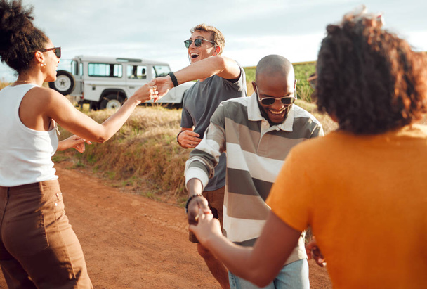 Road trip, travel and friends dancing together celebration for holiday journey, outdoor vacation and adventure lifestyle with car. Happy diversity couple dance by countryside road in summer with love. - Photo, Image