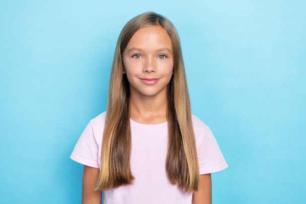 Photo of positive nice cute schoolgirl with straight hairdo wear white t-shirt get ready for school isolated on blue color background. - Foto, Imagem