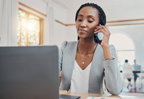 Black woman, on business phone call and communication networking while working on laptop at desk in office. Corporate, professional and do research on internet for planning and strategy - Фото, изображение