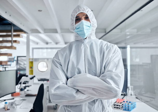Covid, safety and portrait of man in hazmat suit to protect against covid 19 pandemic, risk or corona virus. Ppe, face mask and medical healthcare worker, doctor or scientist in science laboratory. - Photo, Image