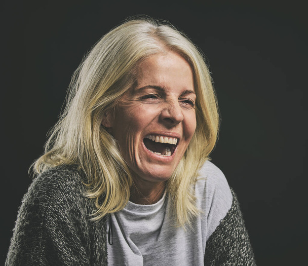 Mental health, depression and woman with bipolar laughing in dark studio. Lady with schizophrenia, anxiety and mental illness with laugh expression. Mockup in psychology, addiction and rehabilitation. - Photo, Image