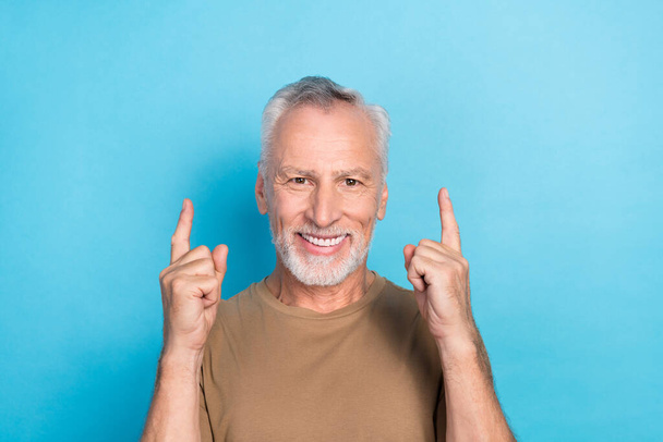 Portrait of positive man raise two arm direct empty space stomatology procedure sale discount low price isolated on blue color background. - Fotó, kép
