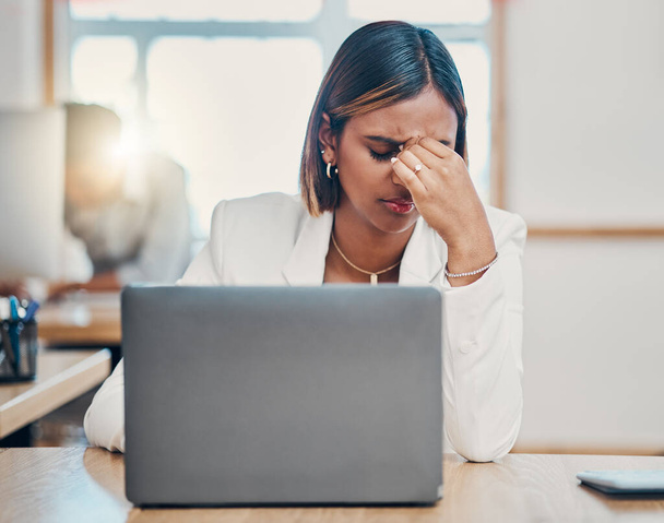Stress, laptop and headache with a woman tax compliance officer struggling with burnout while working on a report or audit. Mental health, regulations and risk with a female employee making a mistake. - Photo, image