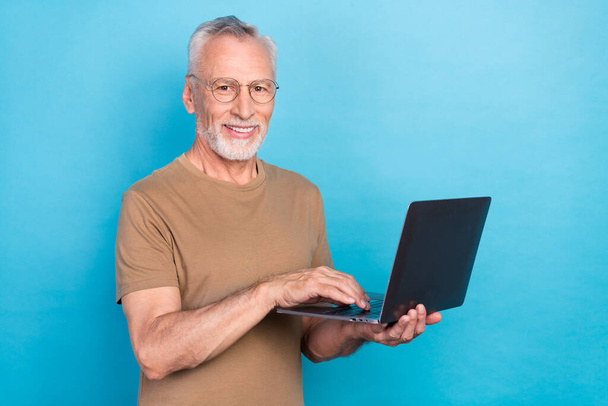 Photo of attractive intelligent man wear trendy pastel learns use netbook device gadget empty space isolated on blue color background. - Valokuva, kuva