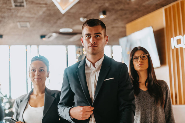Portrait of a successful creative business team looking at the camera and smiling. Diverse businesspeople standing together at startup. - 写真・画像