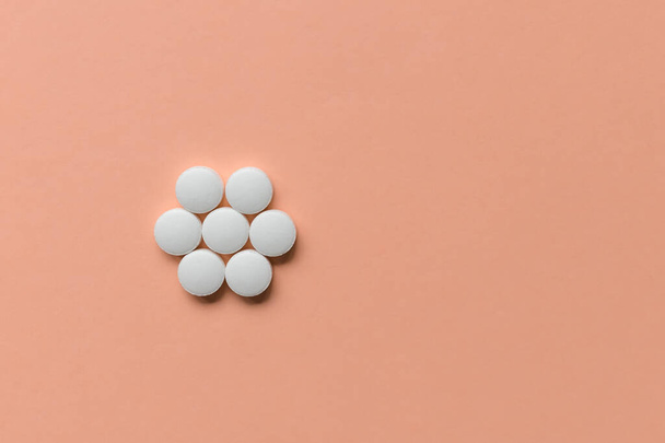 Pills on pink background, supplement, medicine concept. Closeup, copy space - 写真・画像