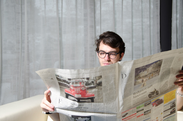 Young man reads newspaper - Фото, зображення