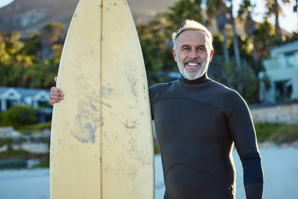 Szörfözés, szörfözés és portré az öregemberről a parton a szörfdeszkájával. Óceán, szörf és idősek vízi sportokat űznek Ausztráliában. Nyár, utazás és boldog érett srác élvezi nyugdíjas a tengerparton. - Fotó, kép