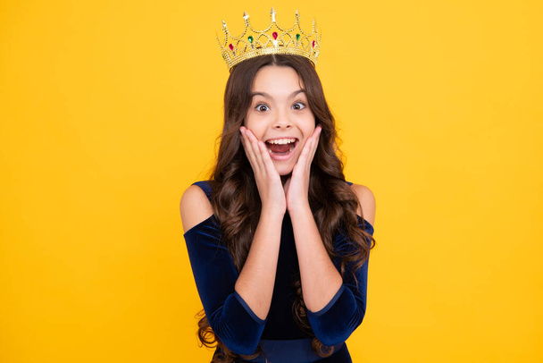 Teenager princess child celebrates success win and victory. Teen girl in queen crown. Excited teenager girl - Фото, изображение