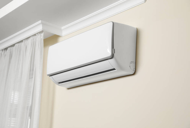 Modern air conditioner on white wall indoors - Photo, Image