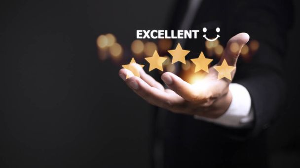 customer hand  with gold five star rating feedback icon and press level excellent rank for giving best score point to review the service, business concept - Photo, Image