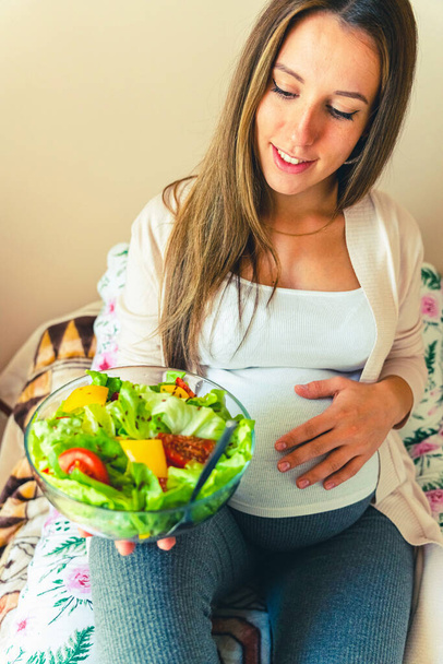 Pregnant salad healthy food. Pregnancy woman eating nutrition diet food salad. Family nutrition, healthy eating concept - Fotó, kép