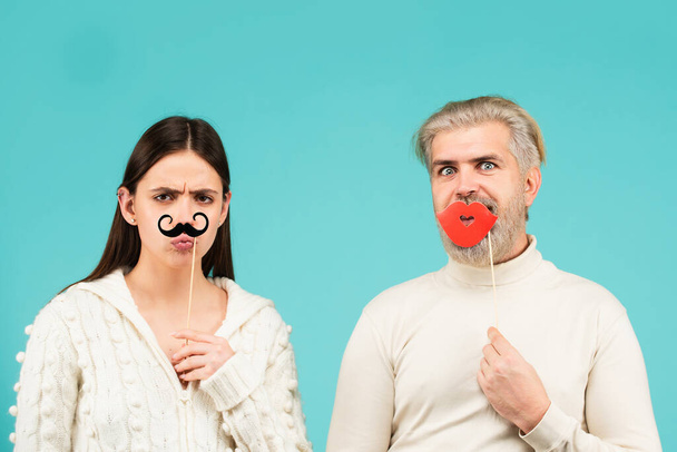 Gender concept. Identity transgender, gender stereotypes. Couple of woman with moustache and man with red lips. Gender equality - Photo, image