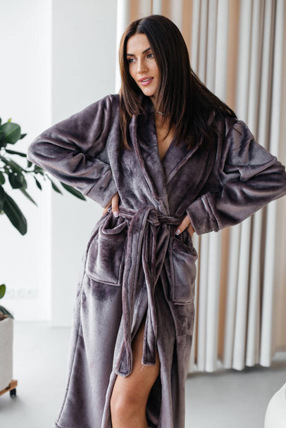 Young healthy serene woman girl relaxing in bathrobe and spa towel after having bath shower at home. Beauty treatment, rest and body care procedures. High quality photo - Foto, Imagen