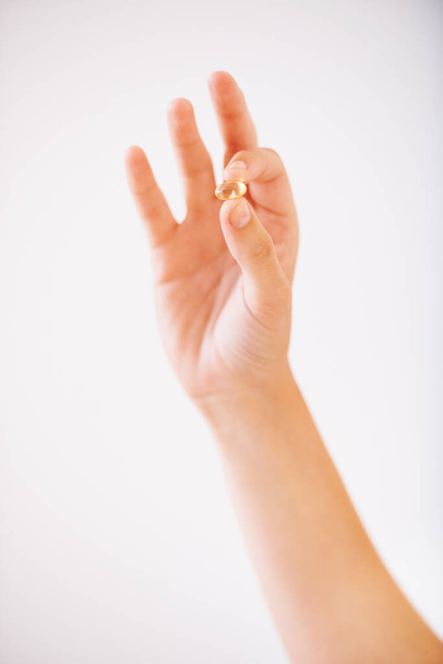 Take one pill every day. Cropped image of a womans hand holding a vitamin - Foto, afbeelding