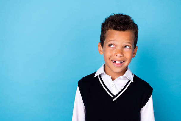 Photo of thoughtful good mood little guy dressed black vest looking empty space isolated blue color background. - Φωτογραφία, εικόνα