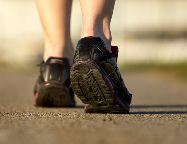 Sports female in black running shoes - Foto, imagen
