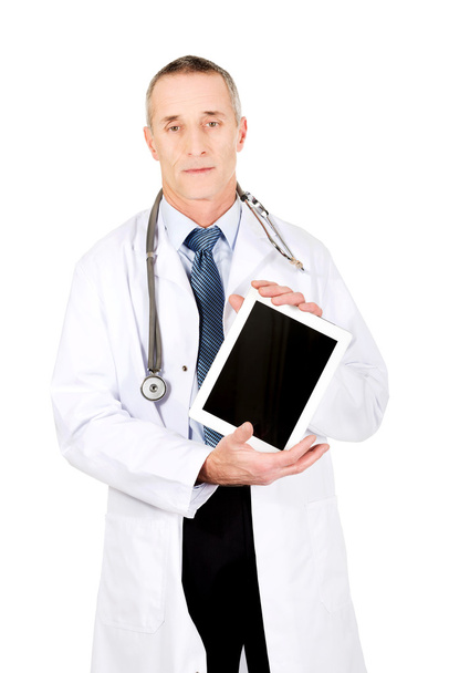 Mature male doctor showing his tablet - 写真・画像