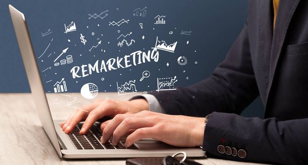 Businessman working on laptop with REMARKETING inscription, modern business concept - Foto, immagini