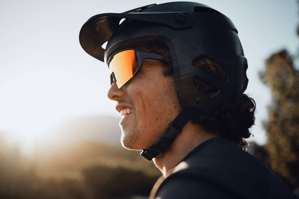 Safety, gear and motorcycle man with helmet and sunglasses in nature forest for outdoor adventure, travel or training with sky sunshine mockup. Healthy sports biking person in the woods for exercise. - Фото, изображение