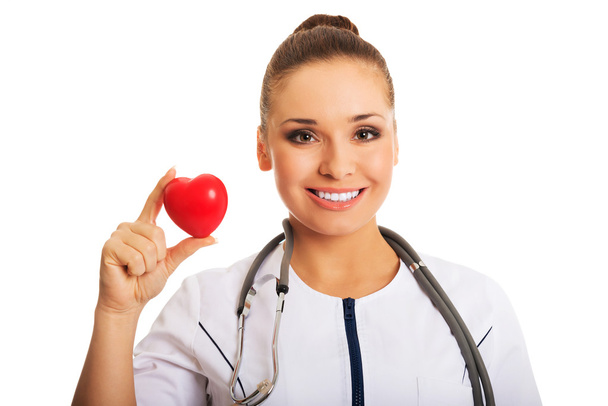 Portrait of female doctor holding heart model - Zdjęcie, obraz
