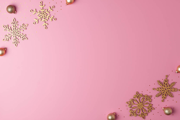 Christmas pink minimal background with snowflakes. Flat lay, copy space - Fotoğraf, Görsel
