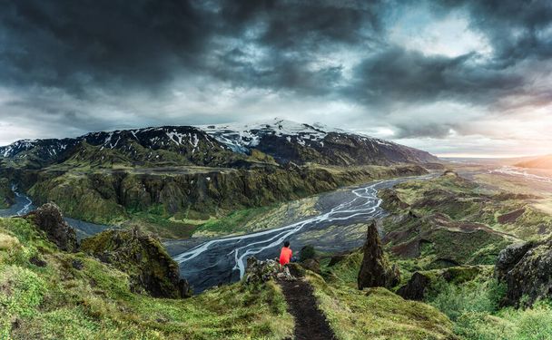 Panorama dramatic view of hiker standing on top of Valahnukur viewpoint among the volcanic mountain and Krossa river in Icelandic Highlands on summer at Thorsmork, Iceland - Φωτογραφία, εικόνα