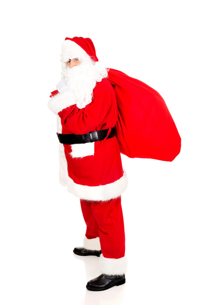 Full length Santa Claus with sack full of presents - Foto, Bild