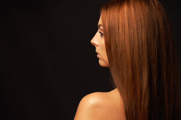 Confident in her beauty. Profile of a beautiful woman on a black background - Fotoğraf, Görsel