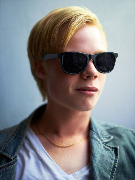 Too cool. Portrait of an attractive young guy wearing hipster shades - Foto, Imagem