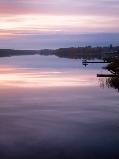 A quiet night by a lake. Mist rises from the water in the distance. - Foto, Imagem