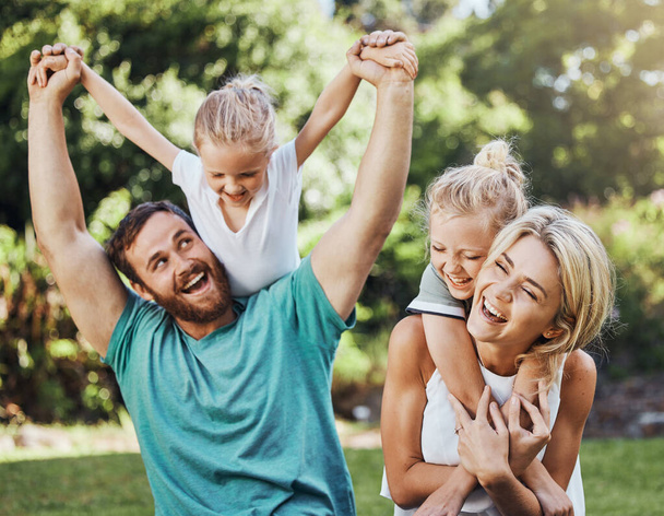 Love, happy and family playing in a park, laugh and relax while having fun together. Freedom, kids and caring parents embracing and enjoying quality time with fun game outdoors, cheerful and positive. - Фото, изображение