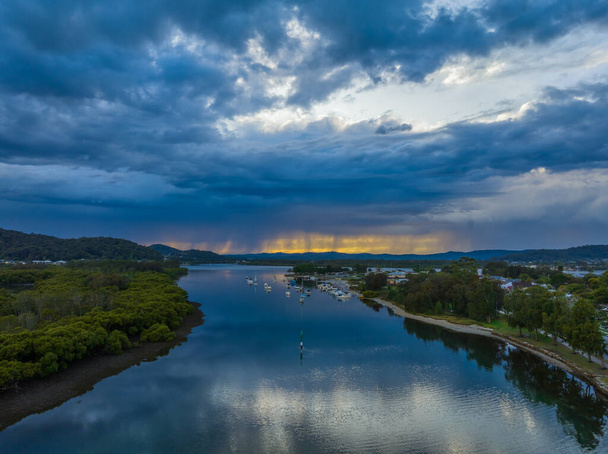 Scenic aerial views as the storm passes over the coastal waters with clouds and reflections in Woy Woy on the Central Coast, NSW, Australia. - Fotó, kép