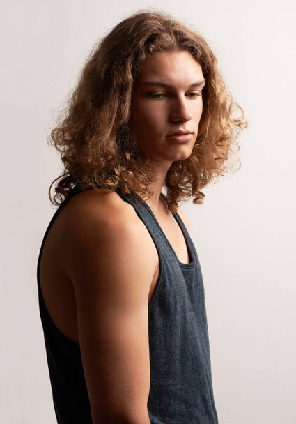 Lost in contemplation. A handsome trendy young man wearing a vest - Foto, imagen