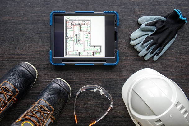 Composition with digital tablet with plan, and builder items, top view. - Photo, Image