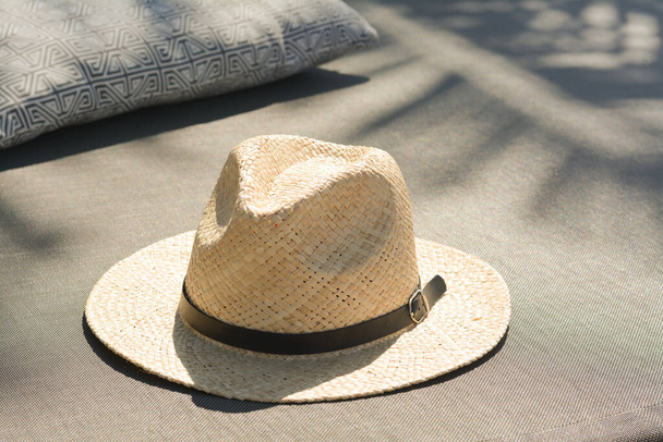 Stylish straw hat and pillow on grey fabric outdoors - Foto, Imagem