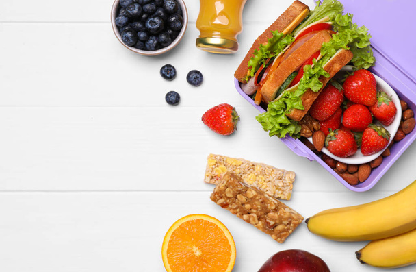 Lunch box with healthy food on white wooden table, flat lay. Space for text - Valokuva, kuva