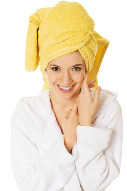 Portrait of young smiling woman in bathrobe - Foto, afbeelding