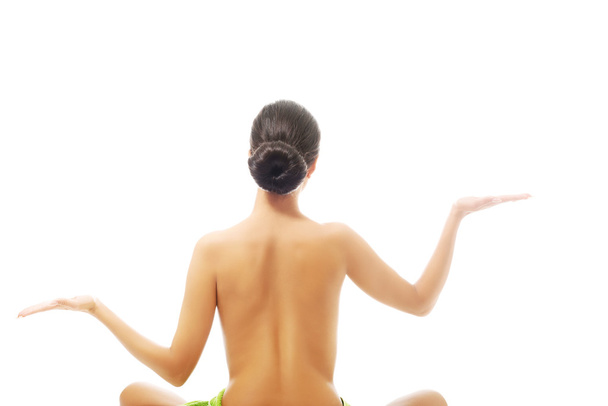 Back view woman sitting excercising yoga - Foto, imagen