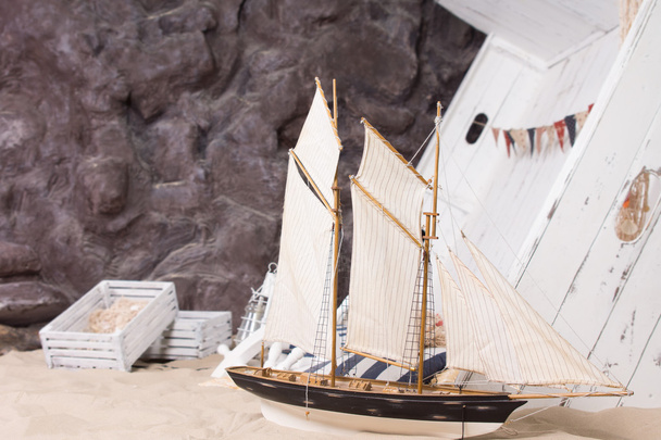 Toy yacht and wrecked wooden ship - Φωτογραφία, εικόνα