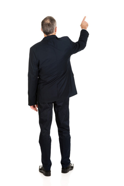 Full length businessman pointing upwards - Фото, зображення