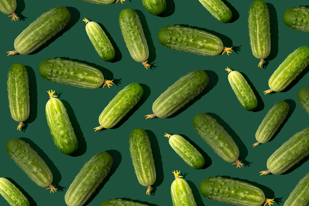 Cucumber pattern. Cucumbers on a green background. Vegetables food - Valokuva, kuva